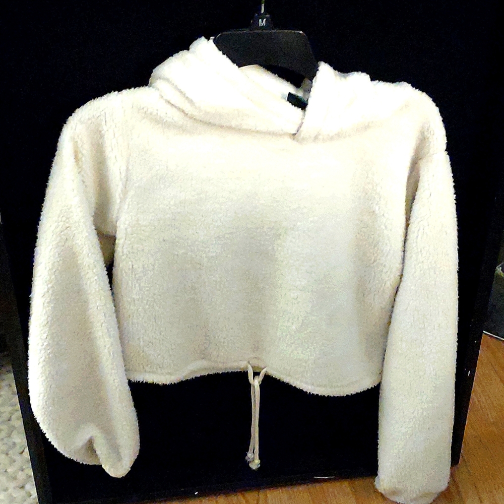 Cream colored fluffy soft hooded crop top.